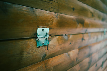 Texture of a wooden wall made of old boards with a metal hinge in the middle.の写真素材