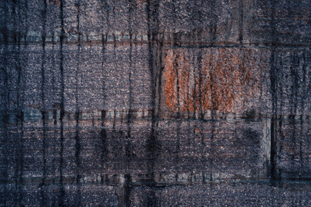 Dirty texture of a wall made of large granite blocks, the effect of time on the material.