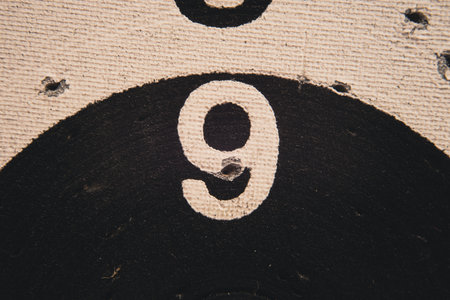 Number 9 on a used dartboard, close up view.の写真素材