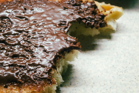 Chocolate cream on a slice of bread, macro view.