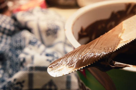 Chocolate cream on kitchen knife, macro view.の写真素材