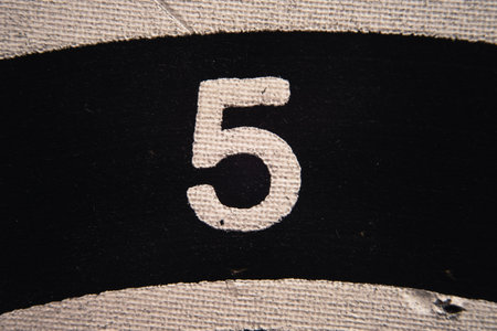 Number 5 on a used dartboard, close up view.の写真素材