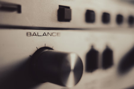 Old hi-fi amplifier, potentiometers and eq markers, macro view.