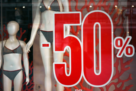 Fifty percent discount at the swimwear store, store window close-up.