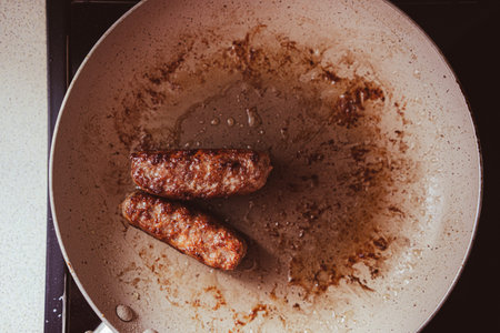 Grilled meat in a pan, close-up view. Food preparation at home.の写真素材