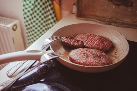 Grilled meat in a pan, close-up view. Food preparation at home.の写真素材