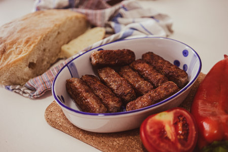 Kebabs in a bowl, homemade bread and some vegetables on the side.
