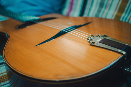 Jazz acoustic guitar on a colorful blanket, details of the instrument.