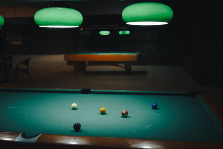 Playing pool in a night pub, details of the table and balls.