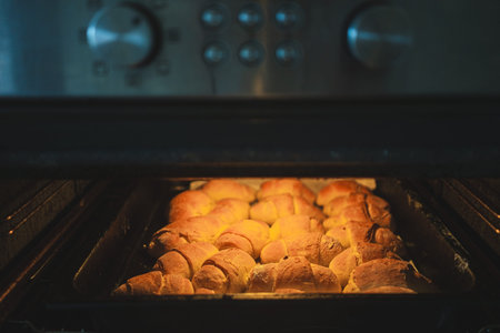Homemade rolls baked in the oven, a scene from ordinary life at home.