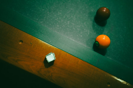 Playing pool in a night pub, details of the table and balls.