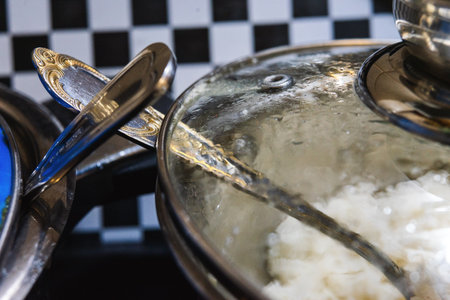 Cooking and storing food in two metal pans with accessories.の写真素材