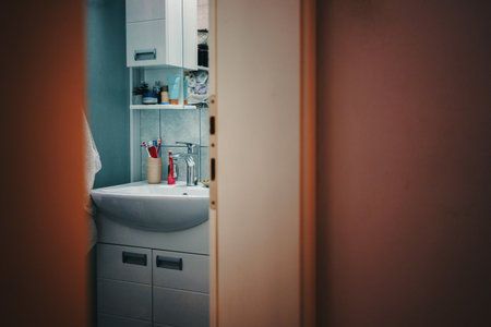 A view of the bathroom, a tap with a sink and hygiene products, a scene from ordinary life.の写真素材