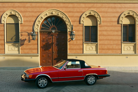 Novi Sad, Serbia - February 08, 2026: Oldtimer Mercedes on the street in front of a building in the...