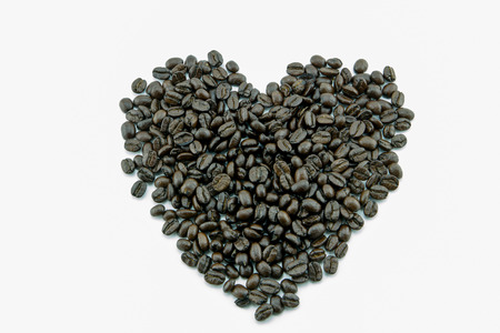 heart from coffee beans isolated on a white background.の写真素材