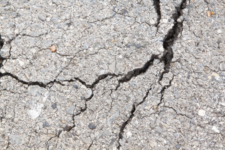 Macro closeup on concrete asphalt cracks on the road.の写真素材