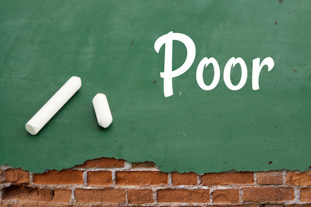 Poor.board on cracked concrete vintage wall background with Chalks.の写真素材