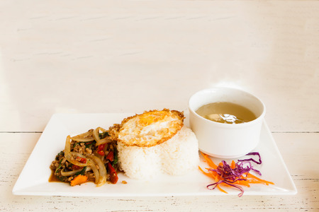 Rice topped with stir-fried pork and basil.の写真素材