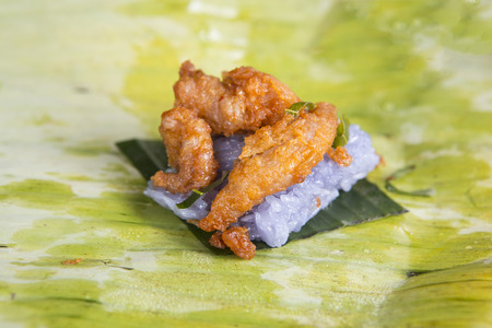 Fried pork with sticky rice on banana leaf.Steamed glutinous rice with fried pork .の写真素材