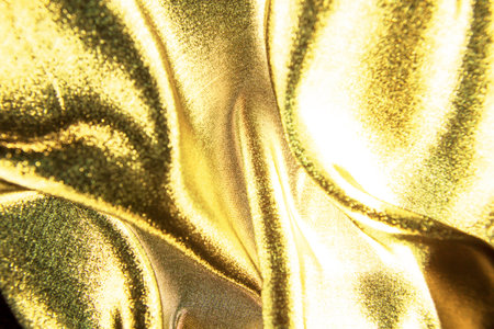 Gold wavy. Luxury cloth or liquid wave or wavy folds of grunge silk texture . Abstract concept.の写真素材