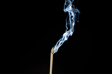 Movement of smoke from  joss stick on black background, Abstract  from smoke on black.