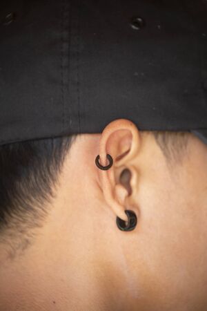 Pierced ear of young boy.の写真素材