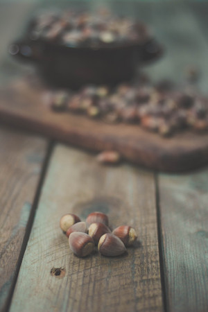 Hazelnuts in a bowl on rustic backgroundの写真素材