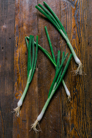 Green Onions on a wooden backgroundの写真素材