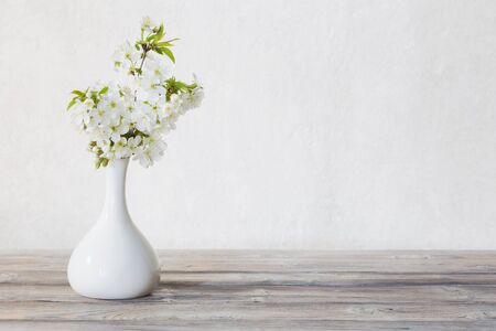 cherry flowers in vase on white backgroundの写真素材