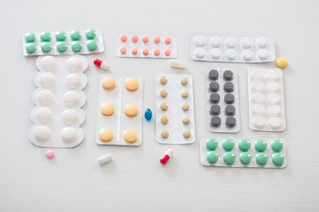 pills on white wooden tableの写真素材