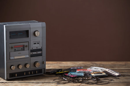 old tape recorder and cassette on  wooden table