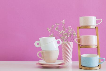 modern cups on white table on background pink wallの写真素材