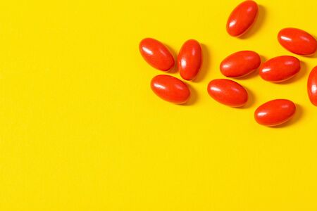 red pills on yellow  backgroundの写真素材