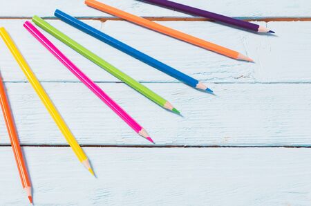 multicolored pencils on blue wooden backgroundの写真素材