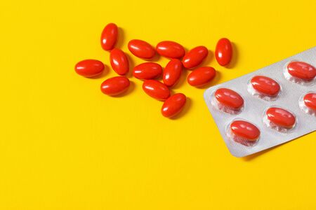 red pills on yellow  backgroundの写真素材