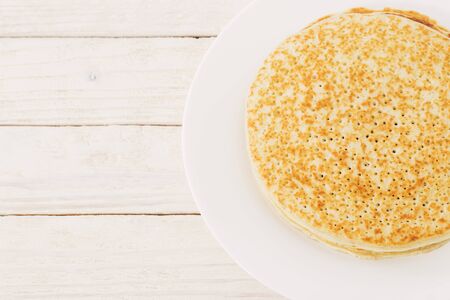 pancakes on plate on white wooden backgroundの写真素材