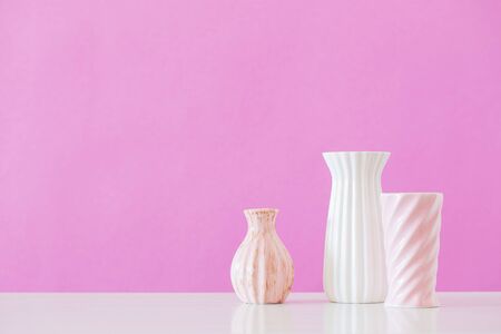 white and pink vases  on pink backgroundの写真素材