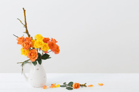 roses in white jug on white backgroundの写真素材
