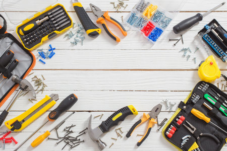 set of repair tools on white wooden background