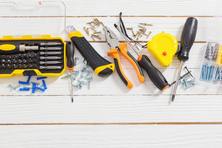 set of repair tools on white wooden background