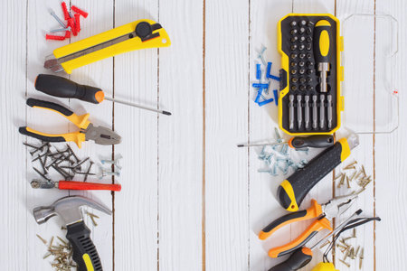 set of repair tools on white wooden background