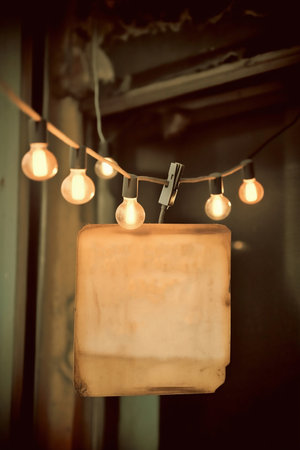 piece of paper hanging on garland with lightsの素材