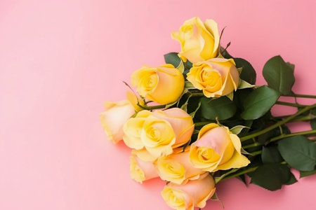 bouquet of yellow roses on pink background top viewの素材