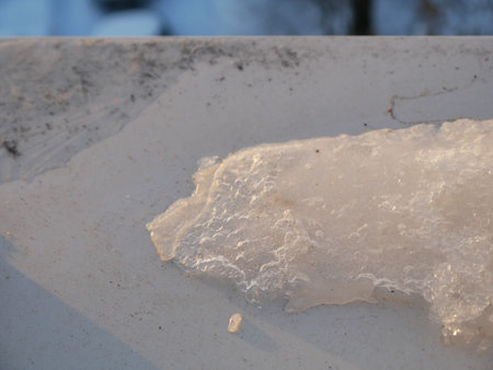 Frozen snow on the street in winter, closeup of photo