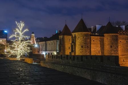 Warsaw, Poland - December 25th, 2016. Barbican fortress wall and Christmas decorations at the Warsaw Old town by Xmas night.のeditorial素材