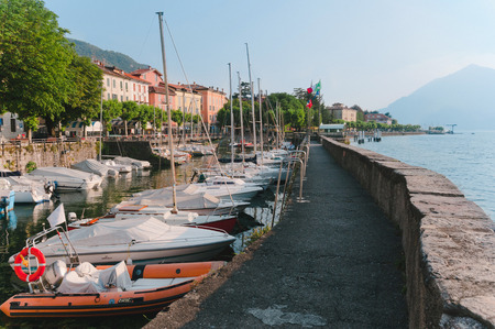 June 13th, 2017 - Lombardy, Italy. Coastline of Bellano fishing village, situated on Como Lake shore. Traditional italian houses, boats in port and embankment in small coast town Bellano.のeditorial素材