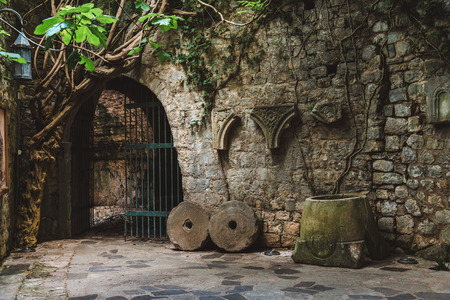 Ancient stone ruins with ivy, fortress wall and gates in Old Bar town, Montenegro. Stari Bar - ruined medieval city on Adriatic coast, Unesco World Heritage Site.の写真素材