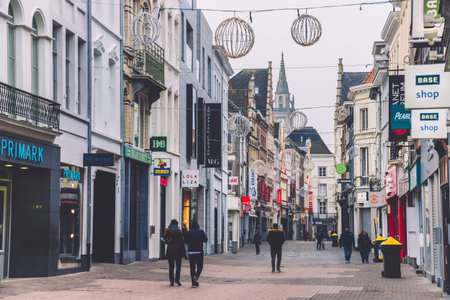 Ghent, Belgium - January 1th, 2017. Medieval flemish city Gent shopping street with modern shops in...