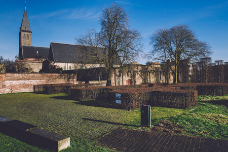 January, 3th, 2017 - Ghent, East Flanders, Belgium. Old medieval church and brick wall of Gent St Bavo abbey also known as Sint-Baafsabdij by sunny day.のeditorial素材