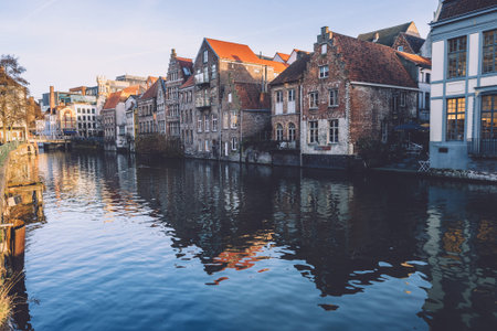 Ghent, Flanders, Belgium - December 27th, 2016. Medieval brick merchant house facades reflected on...